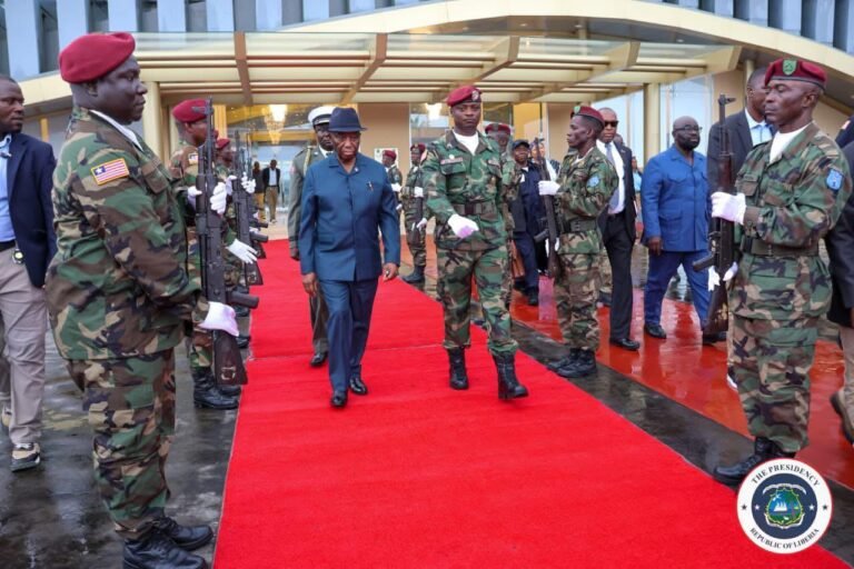 boakai walks on red carpet to leave for the US