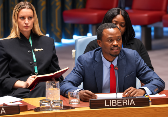Liberia Delegate at Conference Table